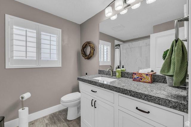1411 E Elm Leaf Cv, Salt Lake City, UT 84117 - bathroom with vanity, wood finished floors, baseboards, curtained shower, and toilet