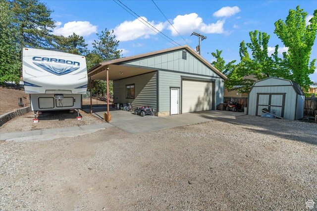 1411 E Elm Leaf Cv, Salt Lake City, UT 84117 - garage featuring a garage, a shed, driveway, and fence