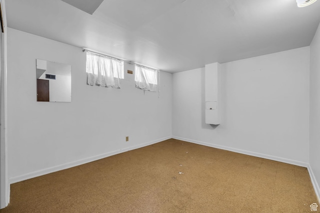 below grade area with tile patterned floors and baseboards