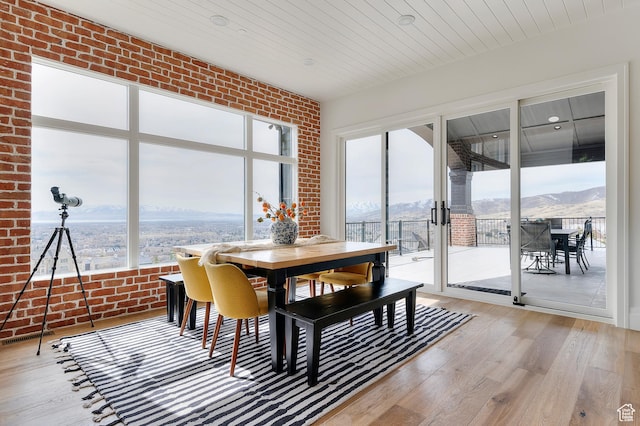 3878 W Oak Hill Dr, Alpine, UT 84004 - dining room featuring light wood finished floors, a mountain view, brick wall, and wood ceiling