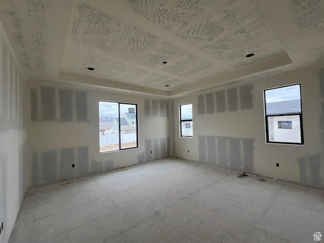 spare room featuring a tray ceiling