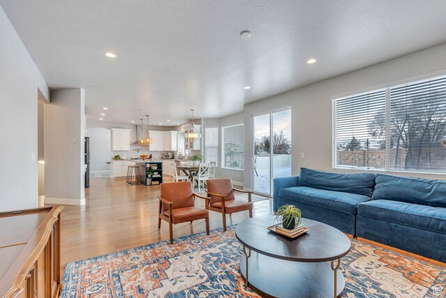 11702 S Water Brook Ct, South Jordan, UT 84095 - living room featuring light wood-style flooring, recessed lighting, and baseboards