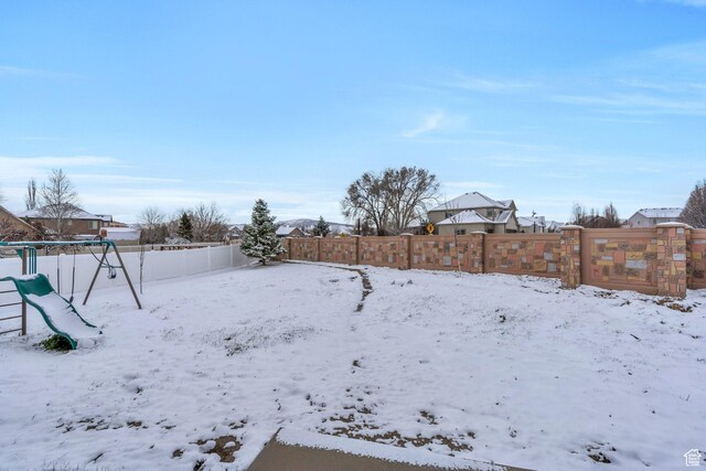 11702 S Water Brook Ct, South Jordan, UT 84095 - snowy yard with a playground and a fenced backyard