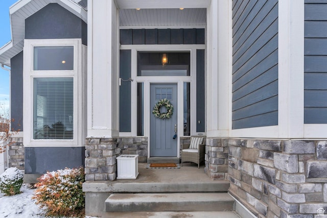 11702 S Water Brook Ct, South Jordan, UT 84095 - doorway to property with stone siding and board and batten siding