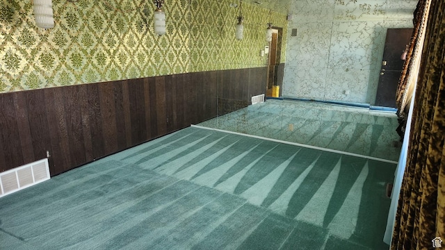 1981 W 3825 S, Roy, UT 84067 - unfurnished room featuring wallpapered walls, carpet, wainscoting, visible vents, and wood walls