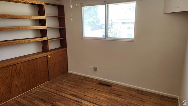 1981 W 3825 S, Roy, UT 84067 - spare room featuring dark wood-style flooring, plenty of natural light, baseboards, and visible vents