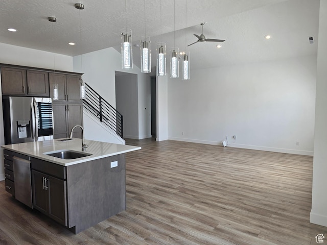 10717 S Haven Vista Dr, South Jordan, UT 84095 - kitchen with ceiling fan, light countertops, light wood-style floors, stainless steel appliances, and a sink