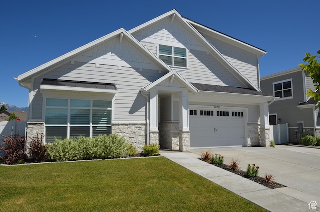 10717 S Haven Vista Dr, South Jordan, UT 84095 - craftsman house featuring a front lawn, an attached garage, stone siding, and concrete driveway