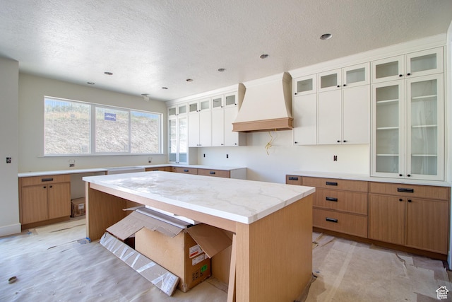 608 E 1310 S, Payson, UT 84651 - kitchen featuring custom range hood, a textured ceiling, glass insert cabinets, recessed lighting, and light countertops