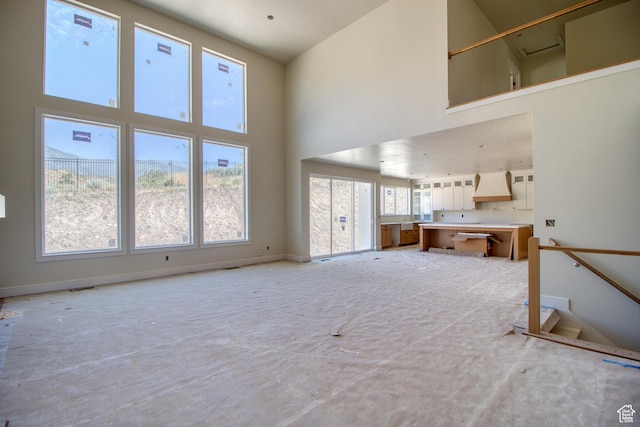 608 E 1310 S, Payson, UT 84651 - unfurnished living room featuring a towering ceiling and baseboards