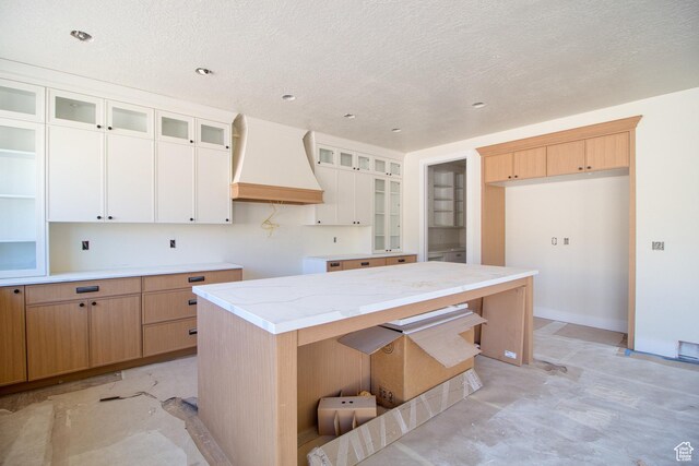 608 E 1310 S, Payson, UT 84651 - kitchen with premium range hood, glass insert cabinets, a textured ceiling, and white cabinets