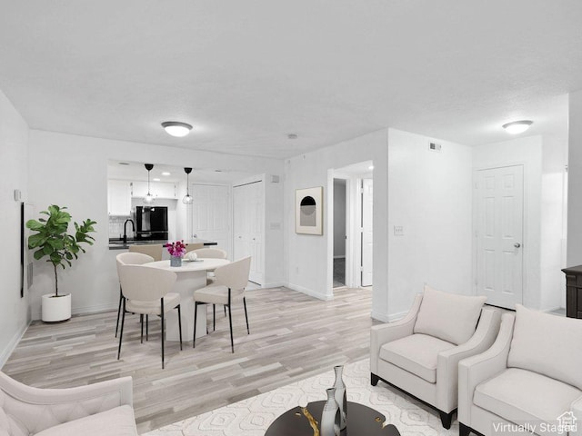 3839 S Canyon River Way Unit 1, South Salt Lake, UT 84119 - living room with light wood-type flooring, visible vents, and baseboards