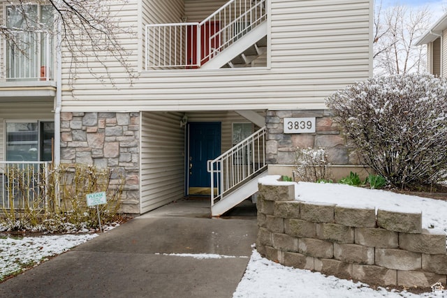 3839 S Canyon River Way Unit 1, South Salt Lake, UT 84119 - view of snowy exterior with stone siding