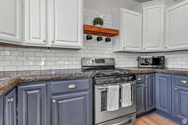 3857 S Windlass Rd W, Saratoga Springs, UT 84045 - kitchen featuring blue cabinetry, tasteful backsplash, dark stone counters, stainless steel appliances, and white cabinetry