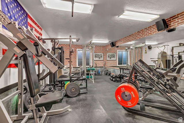 3857 S Windlass Rd W, Saratoga Springs, UT 84045 - exercise room featuring a textured ceiling and brick wall