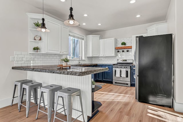 3857 S Windlass Rd W, Saratoga Springs, UT 84045 - kitchen with open shelves, a peninsula, white cabinets, and stainless steel appliances