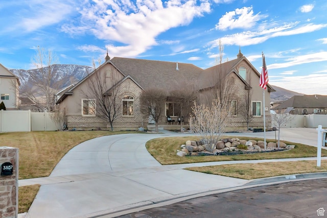 3857 S Windlass Rd W, Saratoga Springs, UT 84045 - view of front of property featuring fence, curved driveway, a front lawn, and brick siding