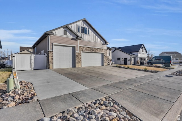 571 S 3350 W, Syracuse, UT 84075 - view of property exterior featuring a gate, driveway, a garage, stone siding, and board and batten siding