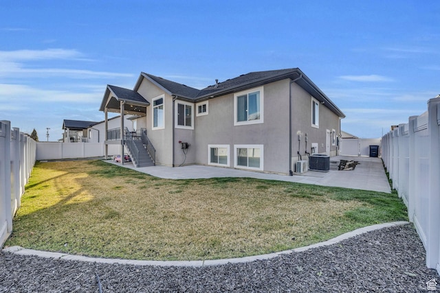 571 S 3350 W, Syracuse, UT 84075 - rear view of property featuring a patio, central AC unit, a fenced backyard, stucco siding, and a lawn