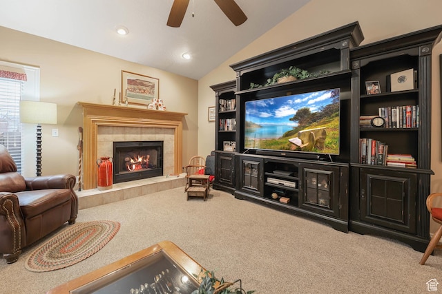living area with a tiled fireplace, recessed lighting, carpet flooring, lofted ceiling, and ceiling fan