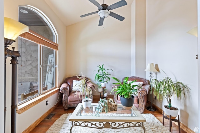 living room with visible vents, a healthy amount of sunlight, wood finished floors, and a ceiling fan