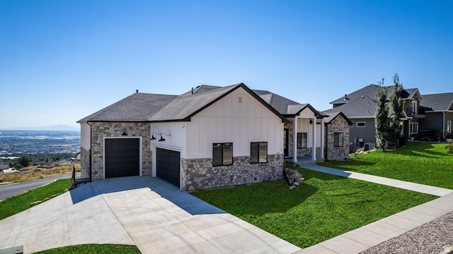 view of front of home featuring a front yard, driveway, stone siding, a garage, and board and batten siding