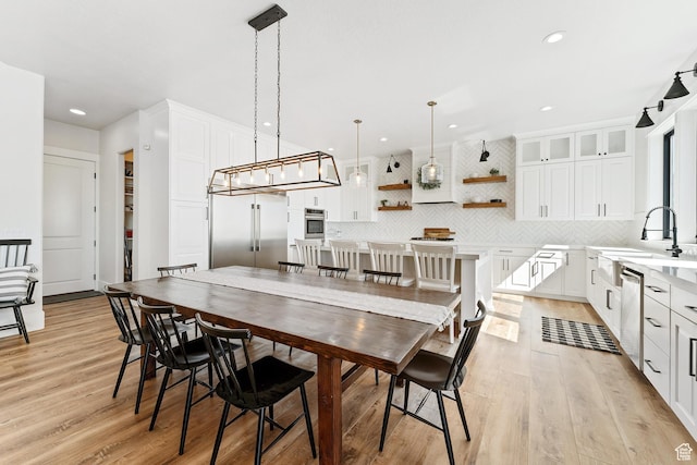 dining area with recessed lighting and light wood-style floors