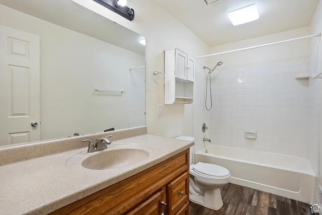 bathroom with vanity, toilet, wood finished floors, and tub / shower combination