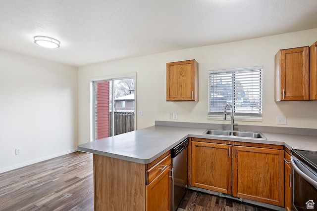 kitchen with a sink, a peninsula, a wealth of natural light, and stainless steel appliances
