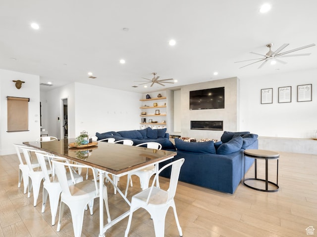 dining area with light wood-type flooring, recessed lighting, and a ceiling fan
