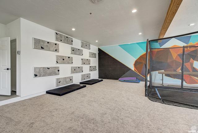 workout room featuring carpet floors and recessed lighting