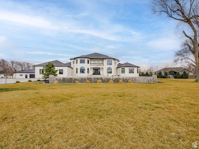 back of house with fence and a yard