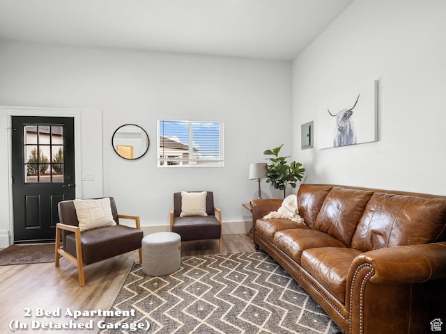 living area with baseboards and wood finished floors