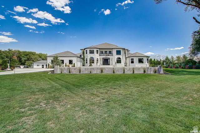 rear view of property featuring a yard