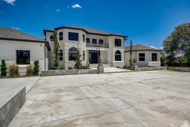 view of front of home featuring a balcony and stone siding