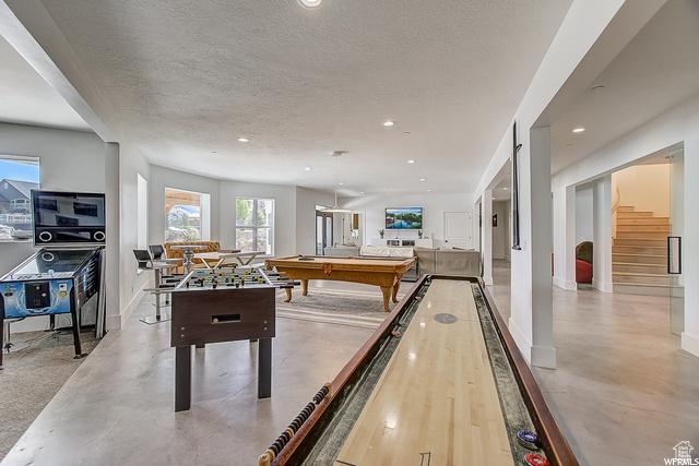 playroom featuring concrete floors, recessed lighting, and a textured ceiling