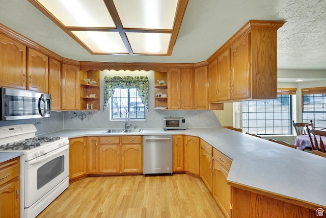600 E 200 N, Mount Pleasant, UT 84647 - kitchen featuring open shelves, light wood-style flooring, appliances with stainless steel finishes, and a sink