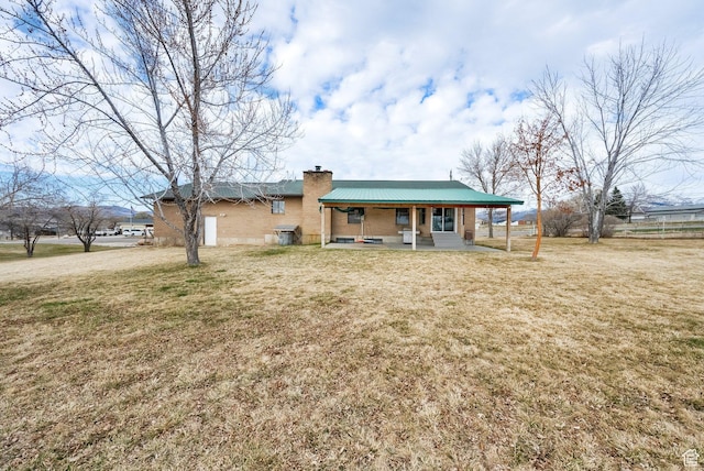 600 E 200 N, Mount Pleasant, UT 84647 - view of front facade featuring a chimney, a front lawn, and metal roof