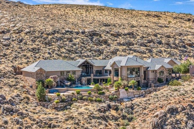 2255 S Hill Rd Unit 14, St George, UT 84790 - back of property featuring an outdoor pool, stucco siding, and stone siding