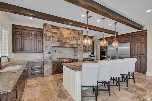 2255 S Hill Rd Unit 14, St George, UT 84790 - kitchen featuring visible vents, backsplash, a kitchen bar, stone tile flooring, and a sink