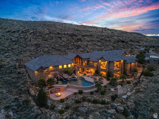 2255 S Hill Rd Unit 14, St George, UT 84790 - back of property featuring stone siding, an outdoor fire pit, and a patio