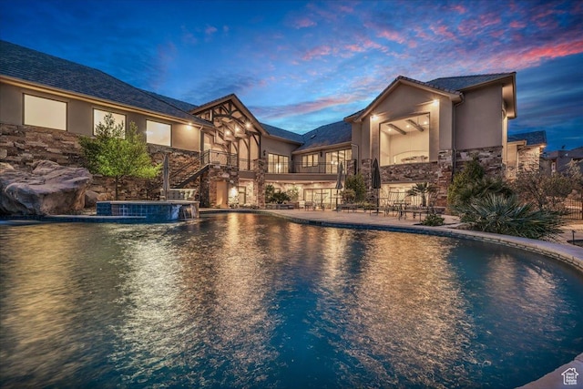 2255 S Hill Rd Unit 14, St George, UT 84790 - exterior space with a balcony, an outdoor pool, stone siding, and stucco siding