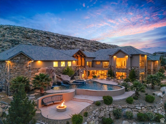2255 S Hill Rd Unit 14, St George, UT 84790 - back of house featuring stone siding, a patio, and an outdoor fire pit