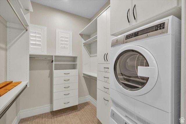2255 S Hill Rd Unit 14, St George, UT 84790 - interior space featuring baseboards, stacked washer and clothes dryer, and laundry area