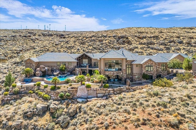 2255 S Hill Rd Unit 14, St George, UT 84790 - rear view of property featuring a patio, a balcony, an outdoor pool, and stone siding