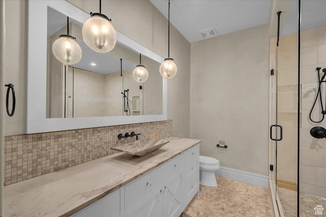 2255 S Hill Rd Unit 14, St George, UT 84790 - bathroom featuring vanity, visible vents, a stall shower, decorative backsplash, and toilet