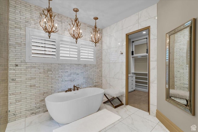 2255 S Hill Rd Unit 14, St George, UT 84790 - full bath featuring marble finish floor, an inviting chandelier, tile walls, a freestanding bath, and a spacious closet