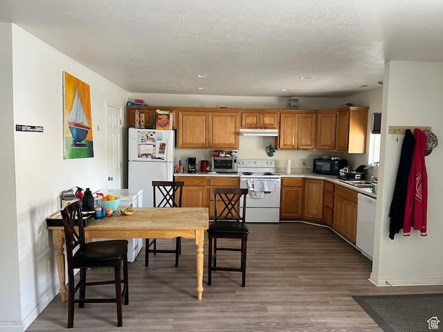 464 N 1000 E, Spanish Fork, UT 84660 - kitchen featuring brown cabinets, wood finished floors, white appliances, a toaster, and light countertops