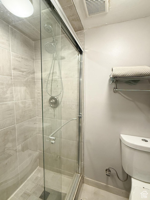1054 34th St, Ogden, UT 84403 - bathroom featuring visible vents, a stall shower, toilet, and baseboards