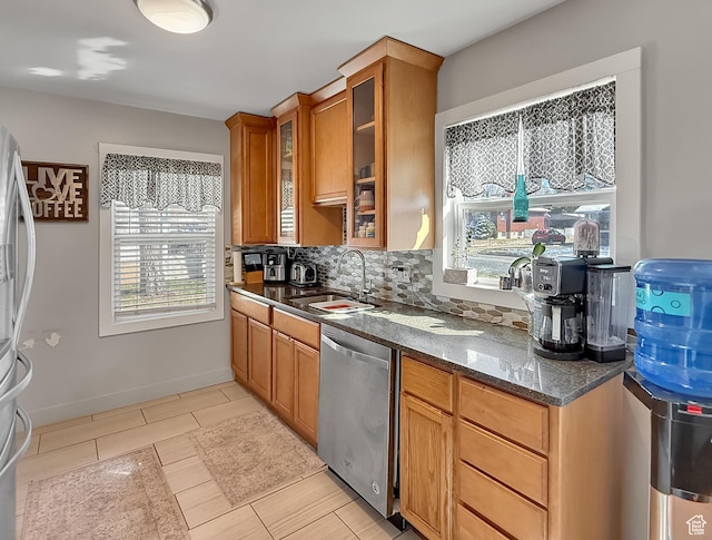 1054 34th St, Ogden, UT 84403 - kitchen featuring a sink, tasteful backsplash, stainless steel appliances, dark stone counters, and glass insert cabinets